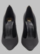 Saint Laurent Saint Laurent Régine Pumps In Black Satin Crepe Feature A Pointed Toe, A 110Mm Stiletto Heel, And A Gold-Tone Ankle Chain Embellished With The Signature Cassandre Logo Charm