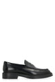 Tod's Tod's Black Full Grain Leather Loafers.  Tod's Monogram Embossed On Front.  Exposed Hand-Stitched Seams.  Leather Piping.  Extra-Light Gum Sole With Distinctive Gommini On Base.  Made In Ital